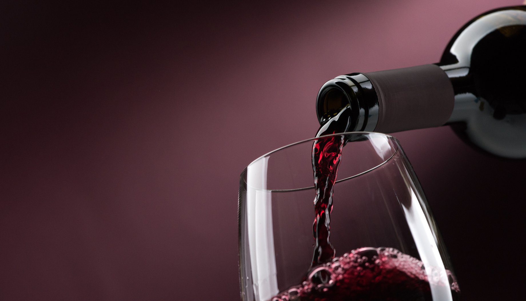 Pouring red wine into a wineglass